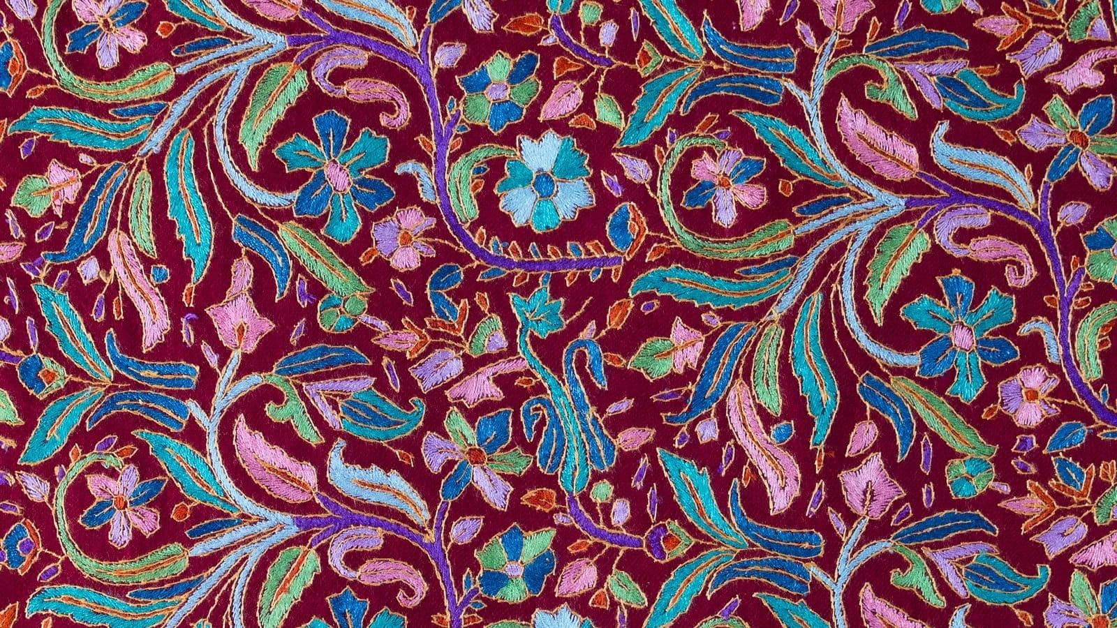 Floral Kashmiri pattern in pink, turquoise and blue on deep maroon